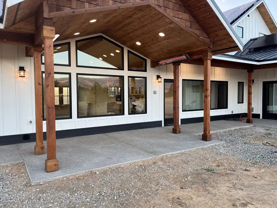 New residence covered porch with recessed lights, a patio heater and wall sconces