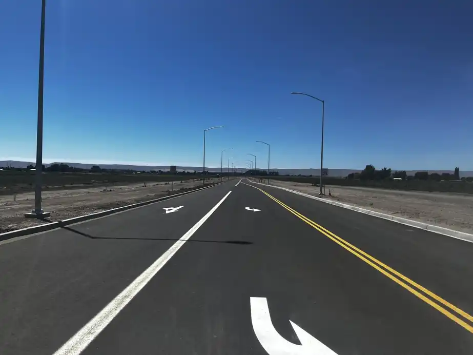 Newly installed street lights along fresh lanes with turn arrows