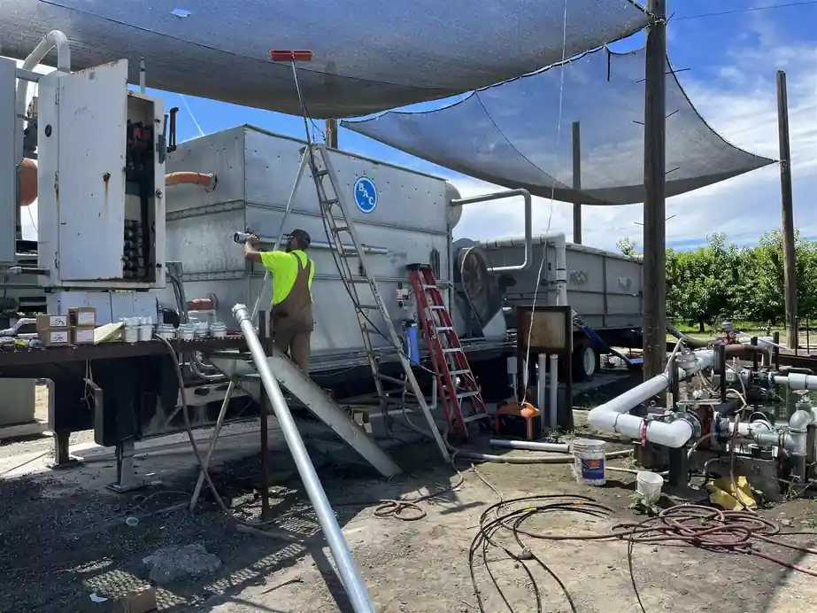 A 509 Electric crew member working from a ladder on an installation