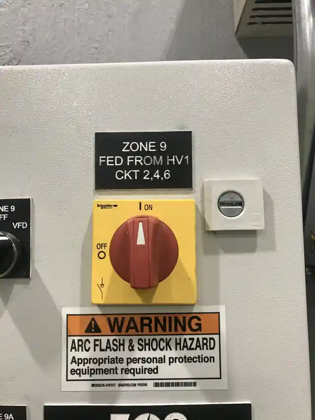 Rotary disconnect labelled Zone 9 fed from HV-1 with an arc-flash warning